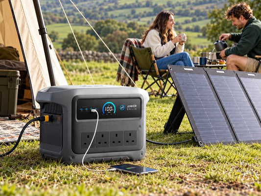 Portable power station charging a phone while camping